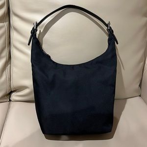 Vintage Coach shoulder bag in black fabric with leather strap.